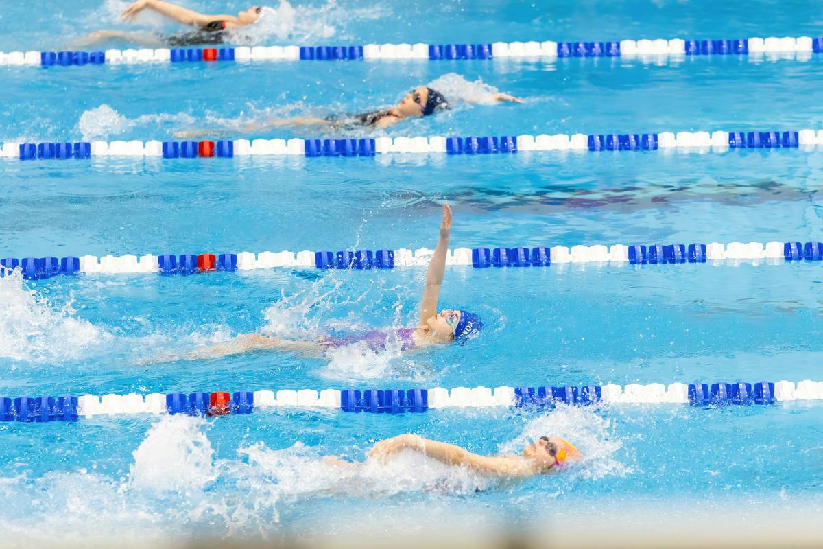 Diverse group smiling after a swim session – showcasing the social benefits of swimming