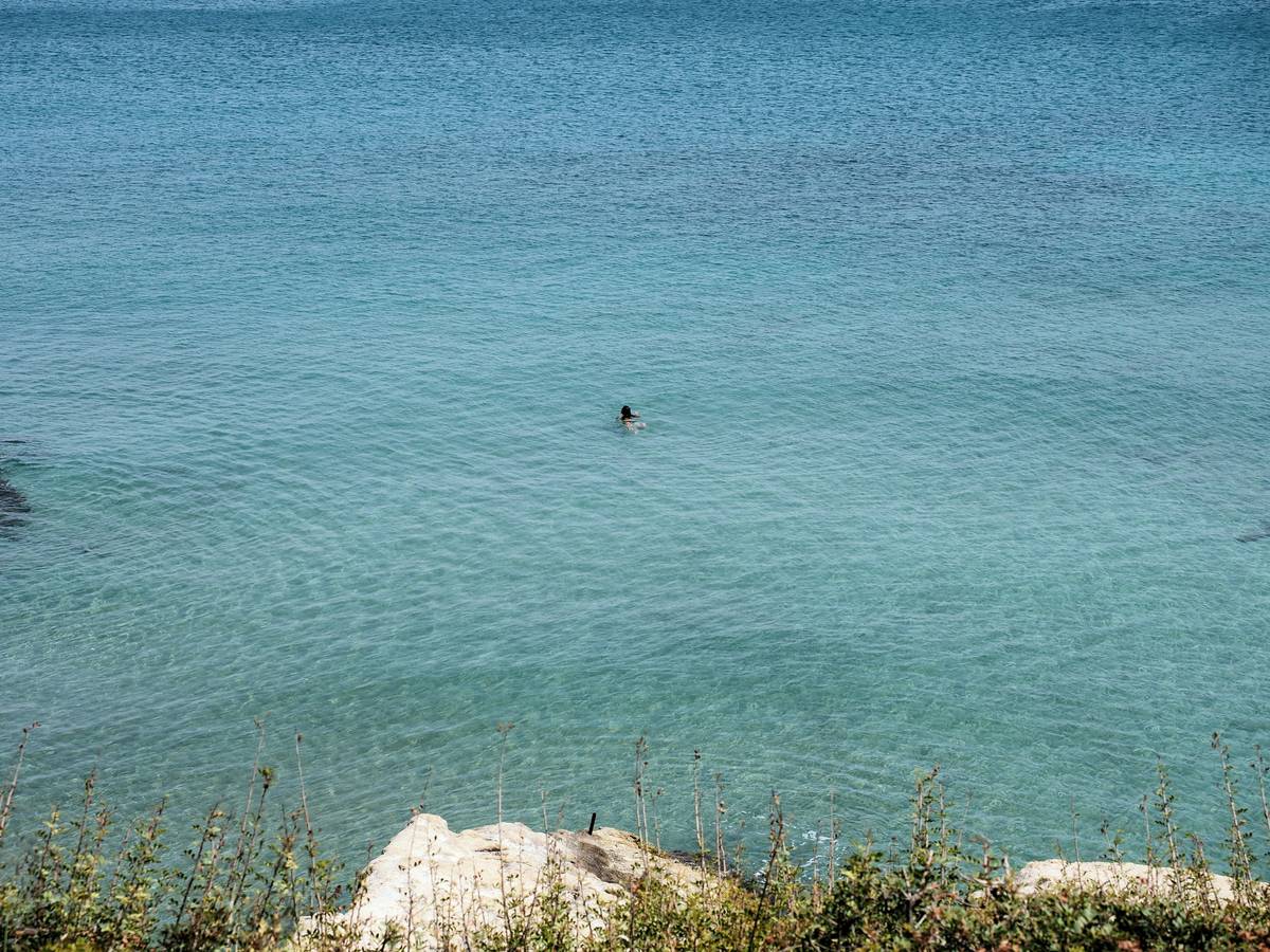 Man enjoying surprising benefits of swimming during unstructured open-water session at dawn